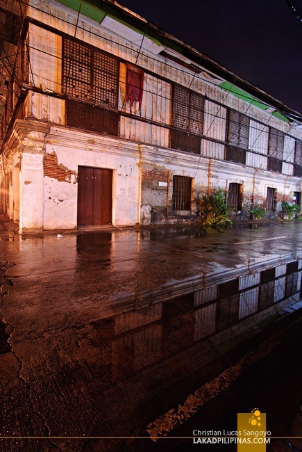 Ancestral House Reflection on Wet Pavement