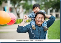 man carrying a boy on his shoulders