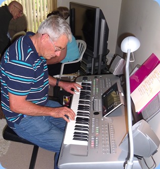 Denis Stewart absorbed in the Tyros 3 keyboard