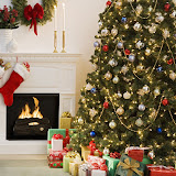 Christmas tree with presents and fireplace with stockings --- Image by © Royalty-Free/Corbis