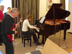 Denise Gunson playing the Yamaha Grand Piano very professionally with Brian Gunson accompanying on his electric guitar
