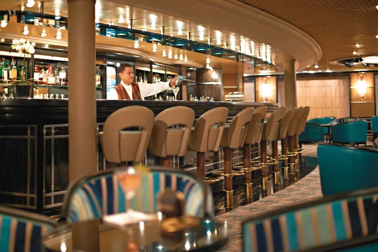 Mingle with other guests at The Bar on Silver Cloud. It features a dance floor, complimentary cocktails and friendly bartenders.