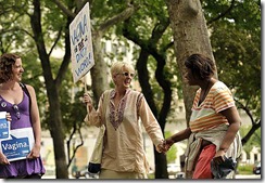 (caption) Sixty-year-old Laura Freeman of Dearborn smiles as she befriends Inez Boynton of Detroit, who was hanging around in Grand Circus Park and was curious about the assembling protestors for SlutWalk Detroit 2012. Freeman's daughter Maggie McGuire (left) watches the interaction.  *** A vocal group composed predominately of women marched down Woodward Avenue to Hart Plaza and through Greektown chanting the word "vagina" along with anti-violence against women slogans during SlutWalk Detroit 2012. Photos taken on Saturday, June 16, 2012.  ( John T. Greilick / The Detroit News )
