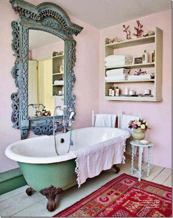 a pink bathroom with clawfoot tub