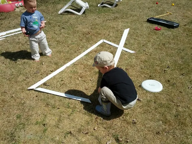 Child building letters as part of an outdoor alphabet activity for kids