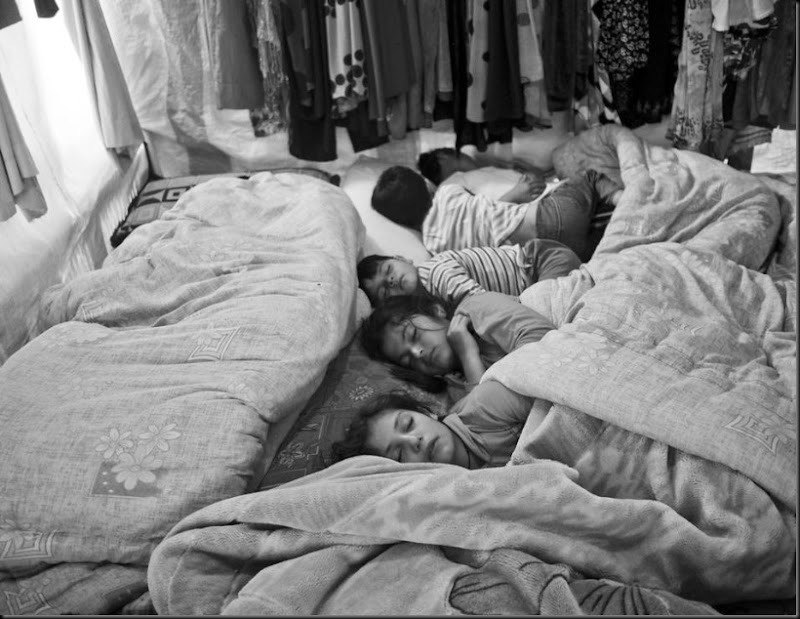 Syrian children sleeping inside their family's tent in the Bekaa Valley, Lebanon. (Moises Saman/Magnum Photos for Save the Children)