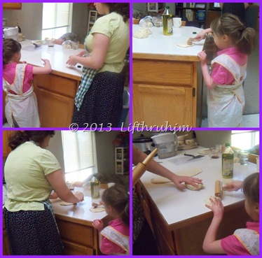 Two sisters rolling out bread dough to shape for loaves.
