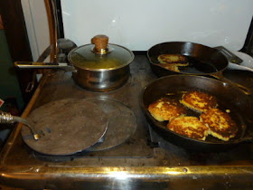 Cooking potato pancakes & applesauce on the wood cookstove.