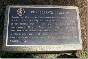 Confederate Cemetery memorial marker in front of the fence of the cemetery.