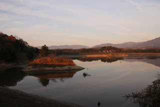 Vista del terrapieno sul lato lago della diga dalla diga del fiume Hino