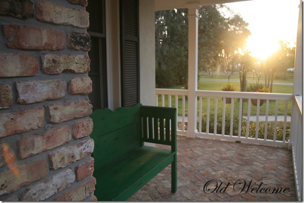 green bench old welcome front porch sun flare