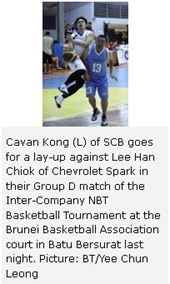 Cavan Kong (L) of SCB goes for a lay-up against Lee Han Chiok of Chevrolet Spark in their Group D match of the Inter-Company NBT Basketball Tournament at the Brunei Basketball Association court in Batu Bersurat last night. Picture: BT/Yee Chun Leong 