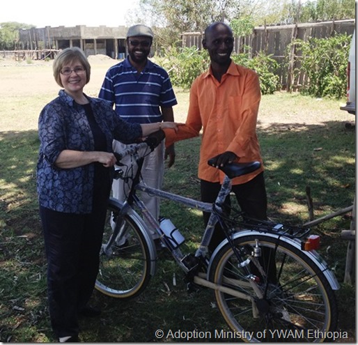 Giving bicycle to evangelist-a