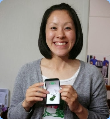 Kuniko showing the greenstone Koru necklace that the Club presented as a thank you to Kuniko for all her wonderful music at the Club and our Community events over the  last 7 months. Everybody signed a card as well to wish her Bon Voyage. Photo courtesy of Dennis Lyons.