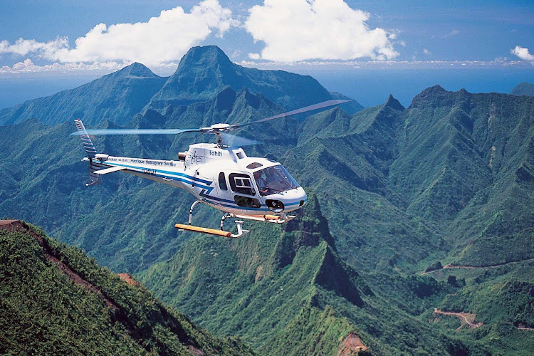 Helicopter tours over Tahiti allow visitors to view the scenic landscapes from a bird's eye view.