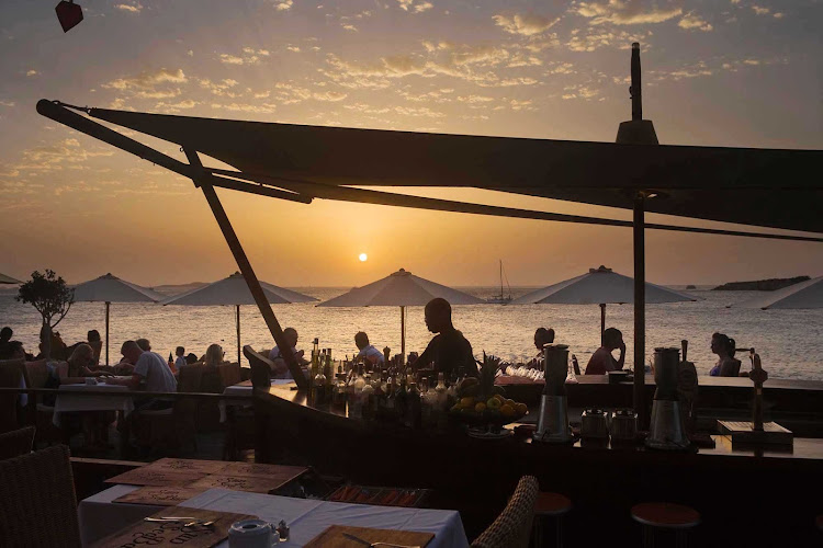 Locals and visitors indulge in Mediterranean fare served at a taverna on the island of Ibiza, in the Mediterranean off the coast of Valencia in eastern Spain at Sun Sea Bar.