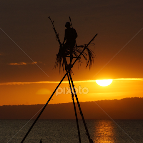 Silhoutted fishermen by Cesar Cambay - Landscapes Sunsets & Sunrises