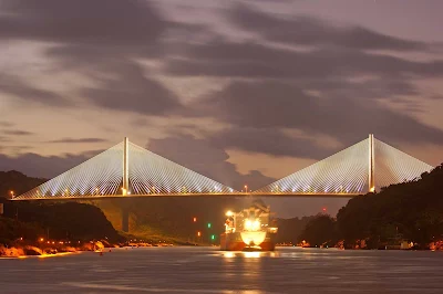 The Centennial Bridge, which crosses the Panama Canal near the Pedro Miguel locks, shimmers in the twilight.