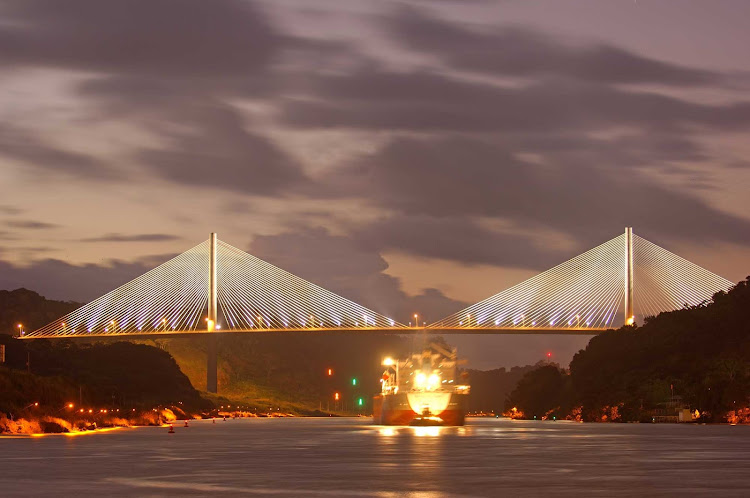 The Centennial Bridge, which crosses the Panama Canal near the Pedro Miguel locks, shimmers in the twilight.