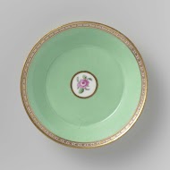 Saucer with roses in a basket