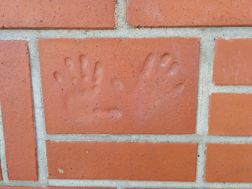 Hands on the Brick Wall