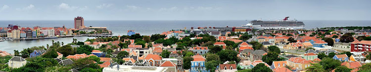 Carnival Breeze sails off the coast of the colorful Caribbean island of Curaçao.