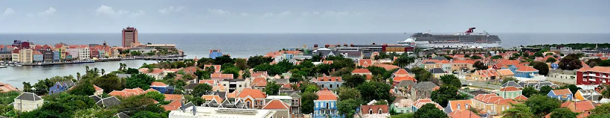 Carnival-Breeze-Curacao - Carnival Breeze sails off the coast of the colorful Caribbean island of Curaçao.