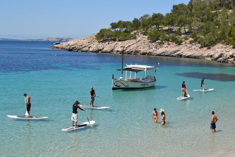 Cala Gració at Sant Antonio Abad in Ibiza off the southern coast of Spain. The beaches there have a pure scenic beauty and are at the hub of many local activities, such as boating, fishing and swimming.