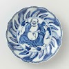 Saucer-dish with Budai and two servants