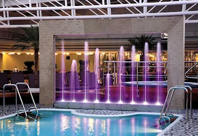 The Lido Pool at midship on Holland America's Eurodam features nine purple fountains that light up at night.
