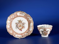 Cup and saucer with a monogram in a crest in a medallion