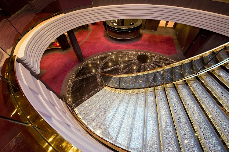 A Swarovski crystal chandelier reflects on the grand staircase inside the  MSC Yacht Club area aboard