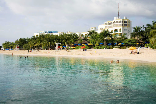 The scene along Doctor's Cave Beach Club in Montego Bay, one of Jamaica's most famous beaches for nearly a century. It's known for its crystal-clear turquoise waters and white sands.