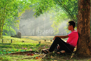 Man sitting alone under tree by Shahril Khmd -  