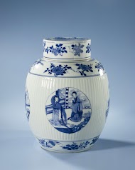Ovoid covered jar with fluted sides and figures in medallions