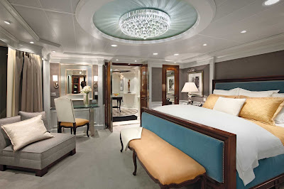 Sail in grand style: A look at the bedroom and its stylish light fixture inside the Owners Suite of Oceania Marina.