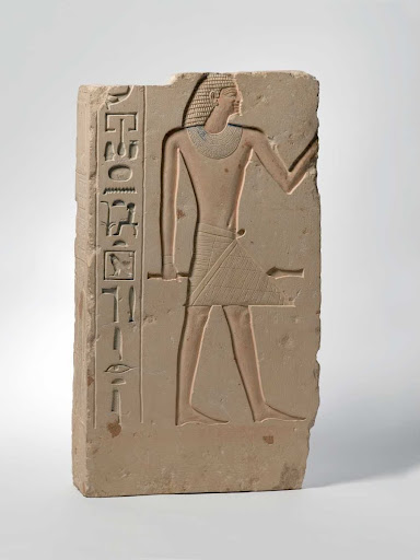 Tomb relief depicting the deceased, whose name is lost, holding a scepter customarily held by high officials