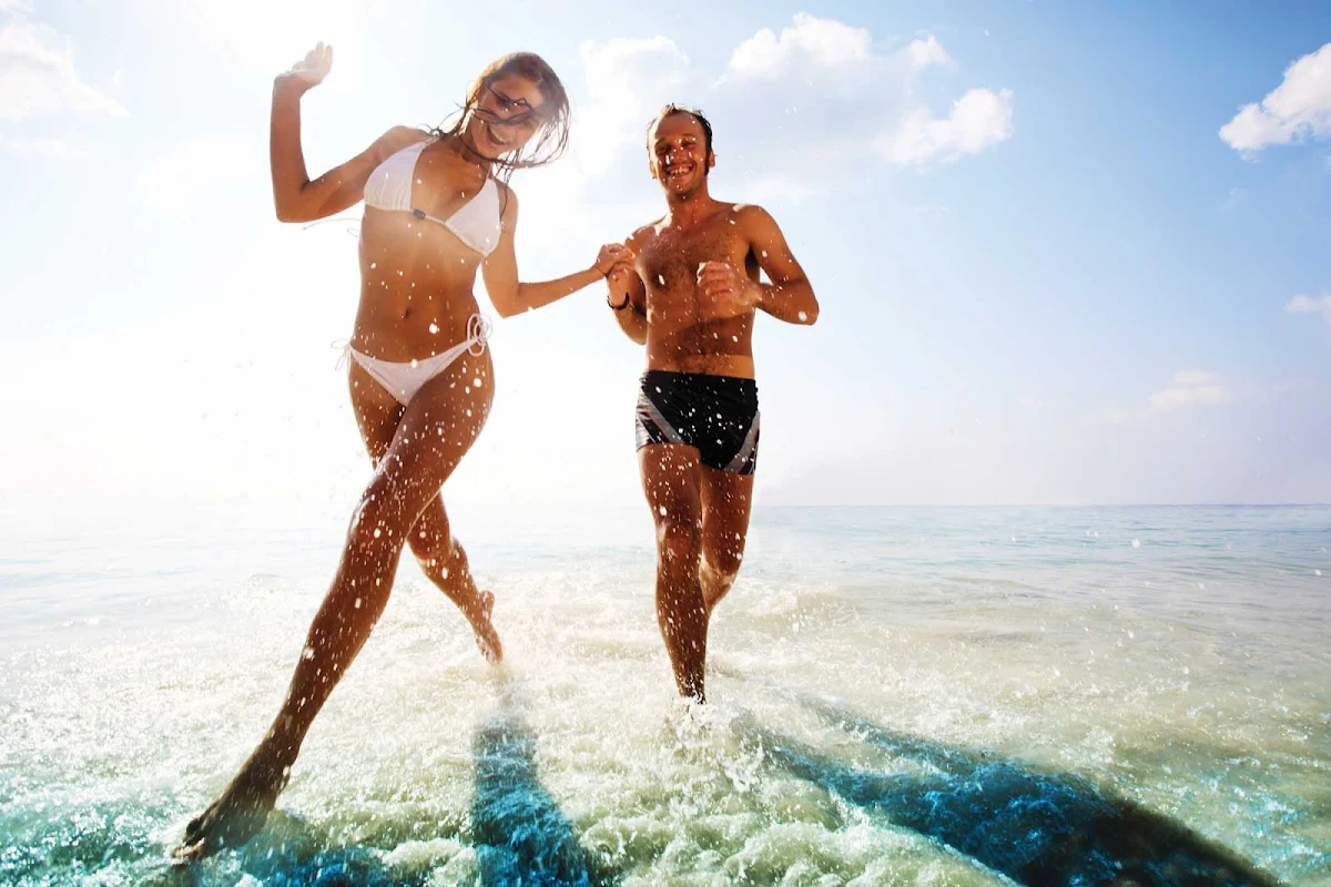 Caribbean-beach-run-couple - Norwegian Cruise Lines offers you passage to a fun, romantic getaway in the Caribbean.