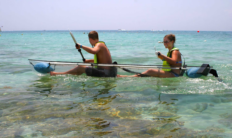 Clear kayaks, available for rent at Cozumel beaches, let visitors pilot their own glass-bottom boat over reefs.