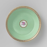 Saucer with roses in a basket