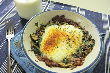 Parmesan baked eggs over bacon, mushroom, leek, and arugula hash