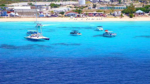boats-grand-turk - Houses and hotels line the shoreline on Grand Turk in Turks and Caicos.