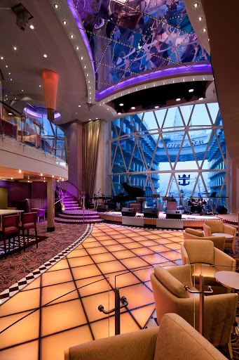 Dazzles aboard Allure of the Seas is a colorful lounge and dance club that spans three decks and offers great views of the Boardwalk.