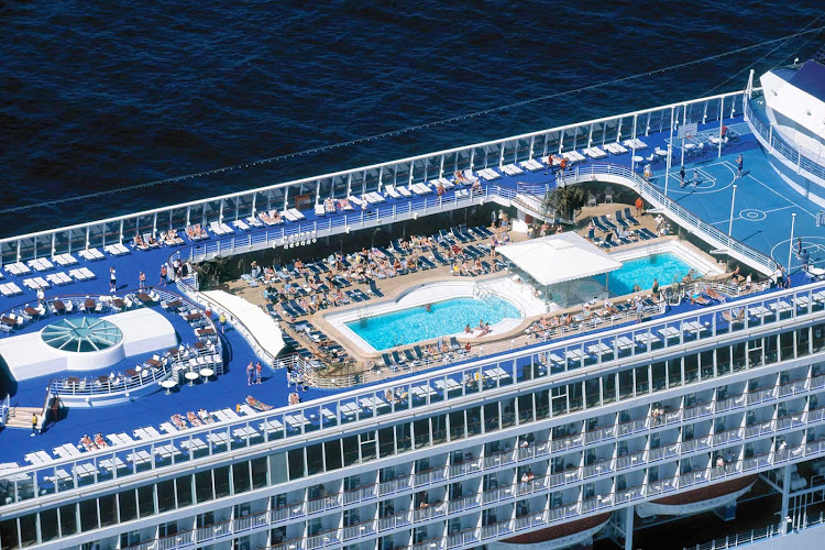 Relax or play hard amid the lounge chairs, pools and nearby bar on Norwegian Sun's pool deck. 