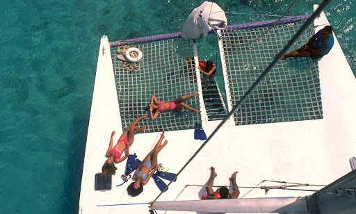 sunbathing-on-watercraft-Aruba - Cruising on a catamaran in the waters of Aruba.
