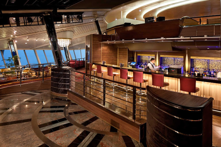 Share a cocktail and the panoramic sea vistas from the Viking Crown Lounge, on deck 11 of Rhapsody of the Seas. 