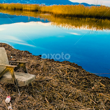 Chair on the Lake Coast  by Vladimir Tufekchiev -  