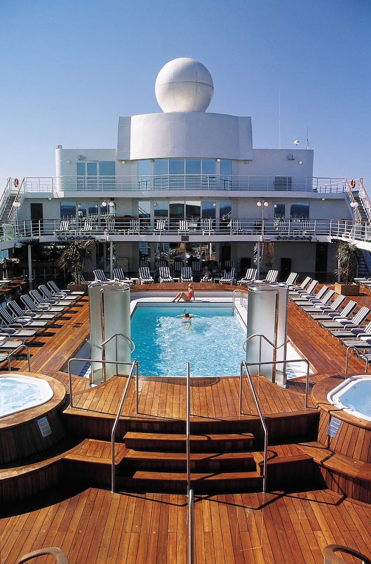 Soak up the sun while reveling in the picturesque views from the pool deck of Seven Seas Navigator.