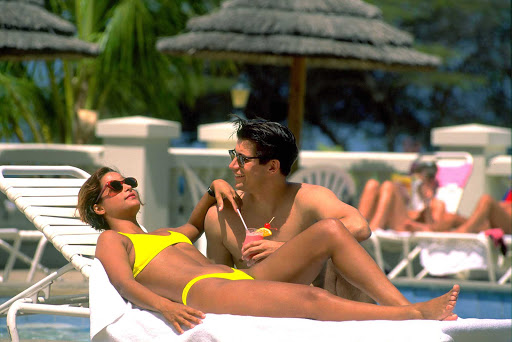 Aruba-couple - A couple relaxes poolside on Aruba.