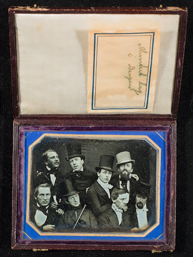 Group portrait of eight men.